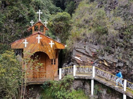 Chapel of the Virgin of Holy Water A man walks along a wooden-railed path leading to the Chapel of the Virgin of Holy Water.